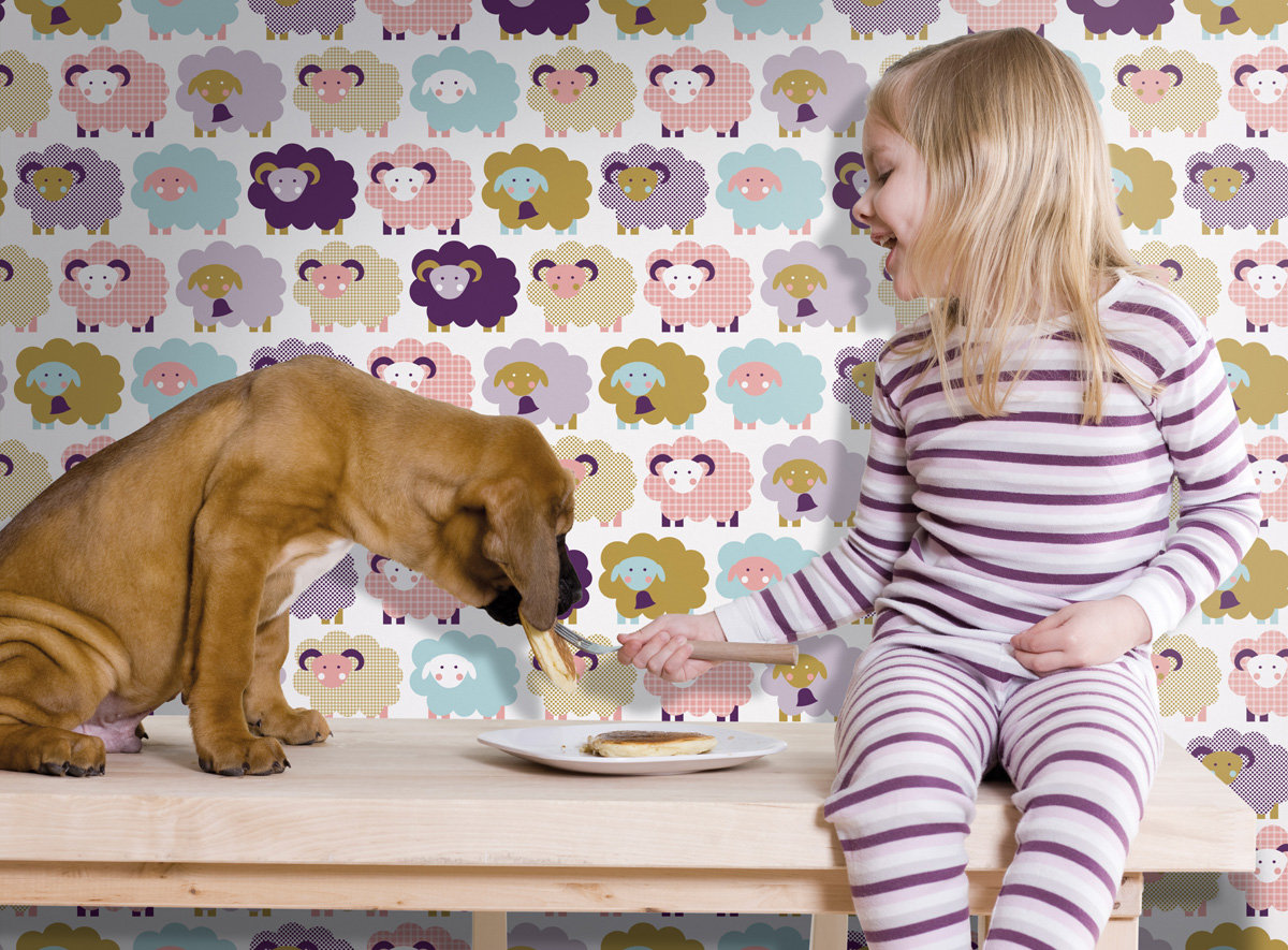 little girl feeding pancakes to her dog